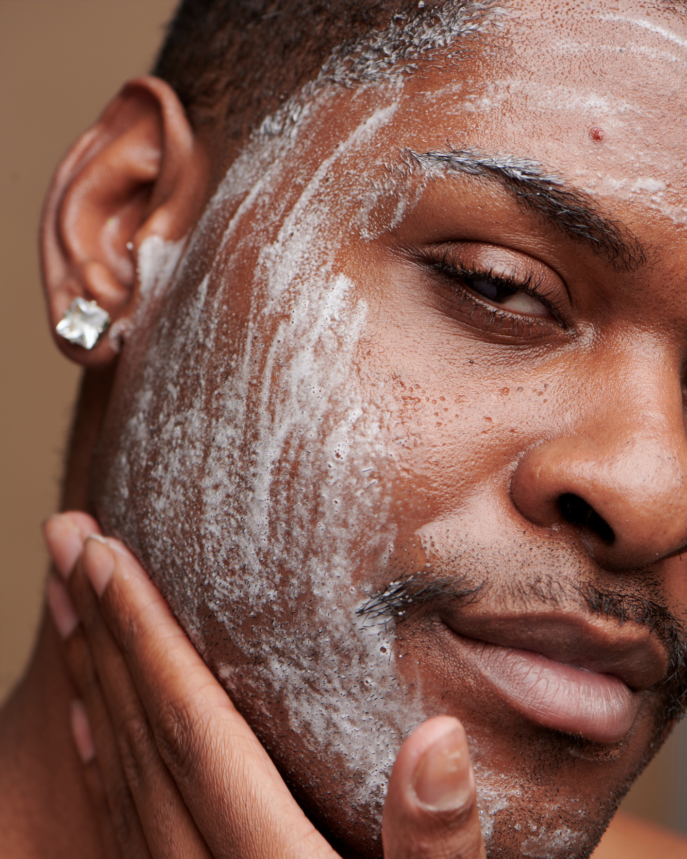 Man Applying Skincare on Face